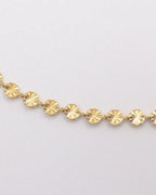 Photo du bracelet rond à maille soleil en acier inoxydable doré à l'or 750/1000ème (18 carats) sur fond blanc