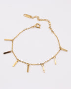 photo bracelet bâtonnets doré sur fond gris clair